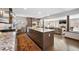 Open kitchen with stainless steel appliances, island seating, and a seamless flow to the living room at 290 Dexter St, Denver, CO 80220