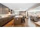Spacious kitchen with island, stainless appliances, hardwood floors, and open to living area at 290 Dexter St, Denver, CO 80220