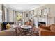 Cozy living room with a fireplace, bay window, hardwood floors, and stylish furnishings at 290 Dexter St, Denver, CO 80220
