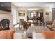 Elegant living room open to dining area, featuring fireplace, modern furniture, and neutral tones at 290 Dexter St, Denver, CO 80220
