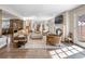 Spacious open-concept living room with a fireplace, large windows, and seamless access to the kitchen at 290 Dexter St, Denver, CO 80220