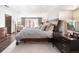 Bright main bedroom showcasing a king-size bed, sitting area, and serene natural light from French doors at 290 Dexter St, Denver, CO 80220