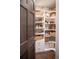 Well-organized pantry with white shelving, drawers, wooden floor and woven baskets at 290 Dexter St, Denver, CO 80220