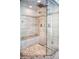 Stunning walk-in shower featuring elegant tile work, dual showerheads, a built-in bench, and glass enclosure at 290 Dexter St, Denver, CO 80220