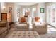 Cozy sitting area with comfortable armchairs, a bay window, and a view of the backyard at 290 Dexter St, Denver, CO 80220