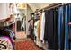 Well-organized walk-in closet with ample hanging space, a full-length mirror, and a decorative rug adding warmth at 290 Dexter St, Denver, CO 80220