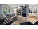 Elegant living room with a fireplace, built-in shelving, and a view of the outdoors at 4915 S Vine St, Cherry Hills Village, CO 80113