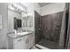 Bathroom featuring a walk-in shower with gray tile, stylish fixtures, and a modern vanity at 494 Black Feather Loop # 108, Castle Rock, CO 80104