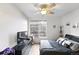 This is a bedroom with a ceiling fan, closet, and a large window that allows for plenty of natural light at 494 Black Feather Loop # 108, Castle Rock, CO 80104