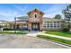 Beautiful stone clubhouse featuring an elegant entrance with a peaked roof and stone accents, set against green landscaping at 494 Black Feather Loop # 108, Castle Rock, CO 80104