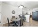 Comfortable dining space with modern lighting fixture and breakfast bar seating into kitchen at 494 Black Feather Loop # 108, Castle Rock, CO 80104
