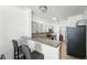 Well-lit kitchen features gray cabinets, stainless steel appliances, granite countertops, and a tiled backsplash at 494 Black Feather Loop # 108, Castle Rock, CO 80104