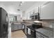 Modern kitchen boasts granite countertops, stainless appliances, and a cozy dining area at 494 Black Feather Loop # 108, Castle Rock, CO 80104