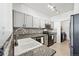 Modern kitchen boasts updated countertops and appliances, with laundry in the next room at 494 Black Feather Loop # 108, Castle Rock, CO 80104