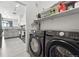 Convenient laundry room featuring a newer Samsung washer and dryer, shelving and a pass-through to the kitchen at 494 Black Feather Loop # 108, Castle Rock, CO 80104