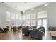 Resident lounge featuring a fireplace, tables and chairs, comfortable seating, and large windows at 494 Black Feather Loop # 108, Castle Rock, CO 80104