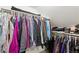 Walk-in closet with a variety of clothing hanging from racks, providing storage and organization solutions at 494 Black Feather Loop # 108, Castle Rock, CO 80104