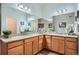 Bright bathroom featuring a double vanity with granite countertops and ample cabinet space at 15852 Lavender Pl, Broomfield, CO 80023