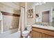 A clean, functional bathroom with tile and granite countertops, offering a practical and pleasant space at 15852 Lavender Pl, Broomfield, CO 80023