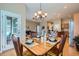 Inviting dining area with a chandelier and natural light, seamlessly connects to living area at 15852 Lavender Pl, Broomfield, CO 80023