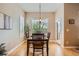 Cozy dining room featuring a chandelier, large window, and hardwood floors at 15852 Lavender Pl, Broomfield, CO 80023