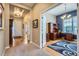 Welcoming entryway with hardwood floors leading to a bright office space with custom built-ins at 15852 Lavender Pl, Broomfield, CO 80023