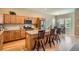 Modern eat-in kitchen featuring granite countertops, stainless steel appliances, and wood floors at 15852 Lavender Pl, Broomfield, CO 80023