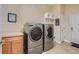 Spacious laundry room with modern washer and dryer, cabinets, and ample storage, ensuring efficiency at 15852 Lavender Pl, Broomfield, CO 80023