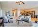 Open-concept living room featuring neutral tones, plush seating, and seamless flow to the kitchen at 15852 Lavender Pl, Broomfield, CO 80023