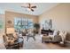 Spacious living room with large windows, neutral tones, and comfortable seating arrangement at 15852 Lavender Pl, Broomfield, CO 80023