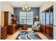 Well-lit home office featuring custom cabinetry, a comfortable chair, and a stylish area rug at 15852 Lavender Pl, Broomfield, CO 80023