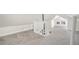 Bright and spacious attic space featuring neutral carpet, white walls, and a small window at 300 Inca St # A, Denver, CO 80223