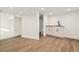 Finished basement with wood-look floors, a utility sink with cabinets, and access to a bathroom at 300 Inca St # A, Denver, CO 80223