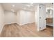 Finished basement with wood-look floors, recessed lighting, and access to a bathroom at 300 Inca St # A, Denver, CO 80223