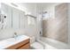 Stylishly renovated bathroom with a modern vanity, toilet, tub, shower, and geometric patterned wall tiles at 300 Inca St # A, Denver, CO 80223