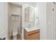 Modern bathroom featuring a wood vanity, updated fixtures, and a walk-in shower with marble tile at 300 Inca St # A, Denver, CO 80223