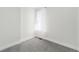 Bright bedroom featuring neutral carpet, white walls, and a window dressed with sheer white curtains at 300 Inca St # A, Denver, CO 80223