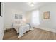 Serene bedroom with natural light, hardwood floors, and a cozy bed creating a relaxing retreat at 300 Inca St # A, Denver, CO 80223