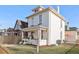 Charming two-story home featuring a well-maintained lawn, classic architectural details, and a welcoming covered front porch at 300 Inca St # A, Denver, CO 80223