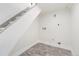 Clean laundry room and stairwell featuring vinyl flooring, neutral walls, and utility hookups at 300 Inca St # A, Denver, CO 80223