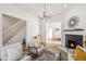 Bright and inviting living room featuring hardwood floors, a decorative fireplace, and a staircase leading to the upper level at 300 Inca St # A, Denver, CO 80223
