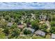 A high angle of the lush neighborhood with mature trees, and colorful rooftops, under a picturesque blue sky at 2440 Saulsbury St, Lakewood, CO 80214
