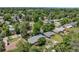 A high angle showing the backyard and neighborhood with mature trees, with mountain views in the distance at 2440 Saulsbury St, Lakewood, CO 80214