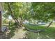 This backyard features a hammock and a mature tree, perfect for relaxing in the shade at 2440 Saulsbury St, Lakewood, CO 80214