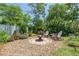 Cozy backyard fire pit area with Adirondack chairs and lush landscaping offers a tranquil retreat at 2440 Saulsbury St, Lakewood, CO 80214