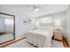 Bright bedroom with a soft color palette, hardwood floors, and stylish decor at 2440 Saulsbury St, Lakewood, CO 80214