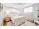 Serene bedroom with white bedding, sheer curtains, and a ceiling fan at 2440 Saulsbury St, Lakewood, CO 80214
