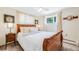 Charming bedroom with carved wood bed frame and natural light at 2440 Saulsbury St, Lakewood, CO 80214