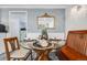 Dining room featuring a glass table and seating, enhanced by a decorative mirror at 2440 Saulsbury St, Lakewood, CO 80214