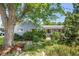 Home exterior with a well-maintained front yard, mature trees, and a charming facade at 2440 Saulsbury St, Lakewood, CO 80214